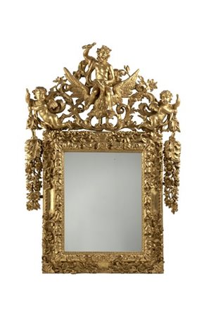 Antica specchiera in legno intagliato e dorato a motivi fogliati, fiori e volut