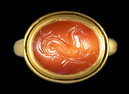 A GREEK CARNELIAN INTAGLIO SET IN A MODERN GOLD RING. SEAHORSE. 