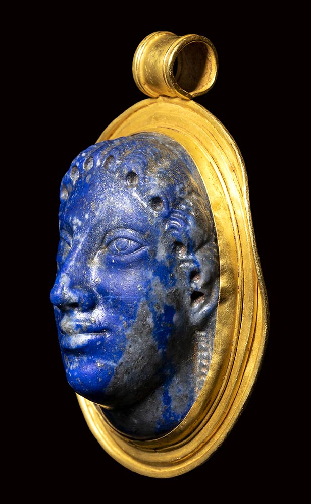 A large postclassical lapis lazuli cameo set in a gold pendant. Head of ...