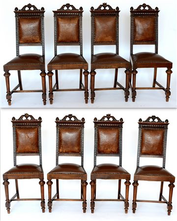 Gruppo di otto sedie in noce con cimasa intagliata e traforata, gambe...
