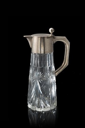 Brocca in cristallo molato con coperchio e manico in argento. Germania, sec....