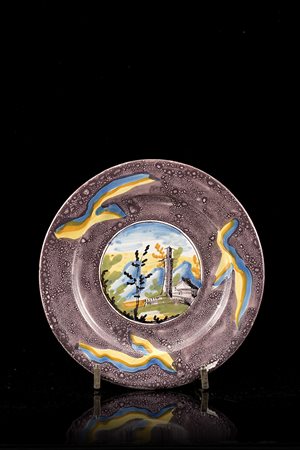 Piatto tondo a bordo liscio in maiolica con ampia bordura a spugnatura in...