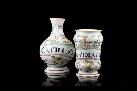 Un albarello (h. cm 20) ed una bottiglia farmaceutica (h. cm 24) in maiolica...