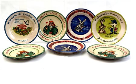 Gruppo di sette piatti del buon ricordo in ceramica policroma (difetti)