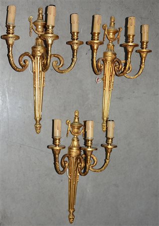 Lotto di tre applique a tre luci in bronzo dorato (h cm 50) (difetti)