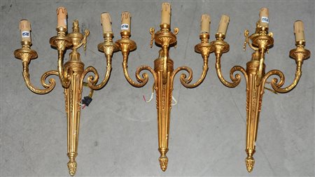 Lotto di tre applique a tre luci in bronzo dorato (h cm 50) (difetti)