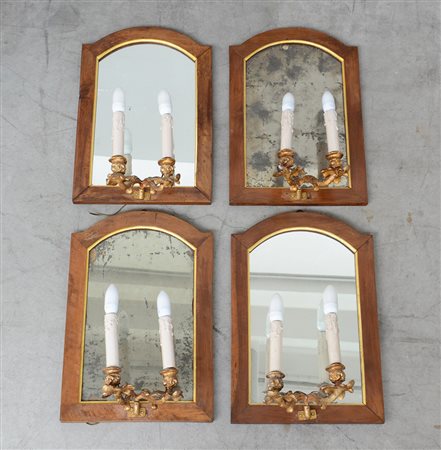 Gruppo di quattro specchiere di forma sagomata montate con appliques a due...