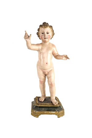 Scultura in legno laccato raffigurante Bambino Gesù benedicente, stante su...