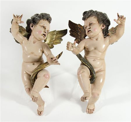 Lotto di 2 putti in legno e legno dorato da parete. H. cm. 37.