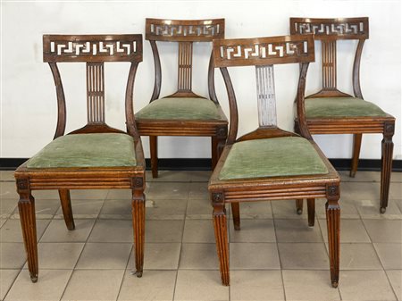 Gruppo di quattro sedie con schienale a giorno intagliato con greca. Sec. XIX...