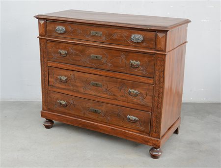 Antico comò in noce a quattro cassetti decorati a motivi floreali intagliati,...