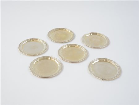 Sei sottobicchieri in argento di forma circolare sagomata. Italia, metà sec....
