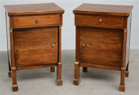 Coppia di comodini in noce ad un cassetto e un'anta con montanti a colonna...