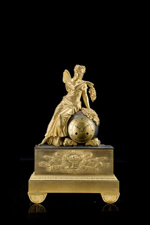 ANONIMO Pendola in bronzo dorato e brunito decorata con figura alataAnni...