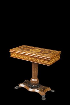 Tavolo da gioco intarsiato e lastronato in legni vari riccamente decorato a...