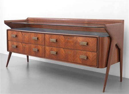 UNA CASSETTIERA, anni '60. Legno di palissandro, legno impiallacciato in...