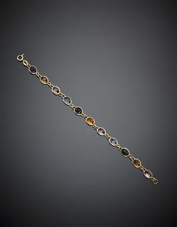 Bracciale in oro giallo composto da undici gemme di vario colore e natura,...