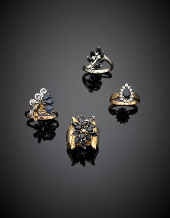 Lotto di quattro anelli in oro giallo, bianco e rosso con zaffiri e diamanti,...