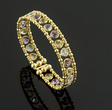 Bracciale rigido in oro e pietre dure. gr. 25,3.