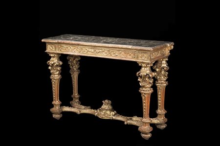 Consolle in legno intagliato e dorato a volute fogliate concatenate...