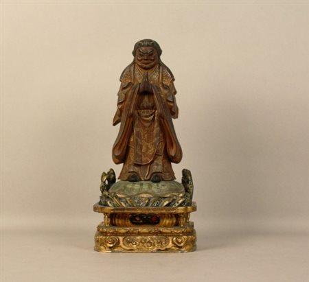 Firmato, datato. Scultura in legno esotico laccato e dorato raff....