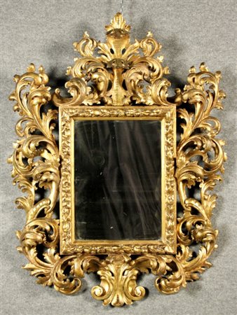 Firmato, datato. Specchierina in legno intagliato e dorato. XVIII secolo....