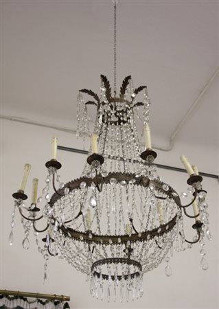 Firmato, datato. Lampadario dodici bracci modello impero con file di gocce in...