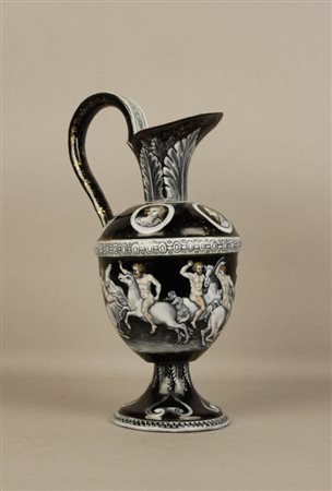 Antico versatoio in smalto nero con raffigurazioni di scene mitologiche....