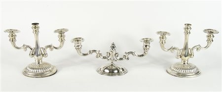 Lotto di 3 candelieri in argento di cui 2 in coppia a 3 luci. H. max cm. 19.