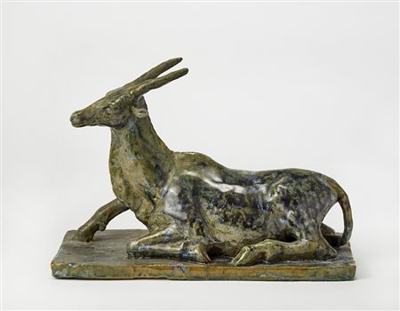 "Stambecco" Scultura in terracotta smaltata a colature verdi e blu. Italia,...