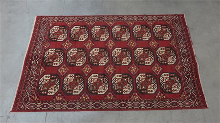 Tappeto meccanico con disegno Bohukara su fondo rosso, sec. XX (cm 274x178)...