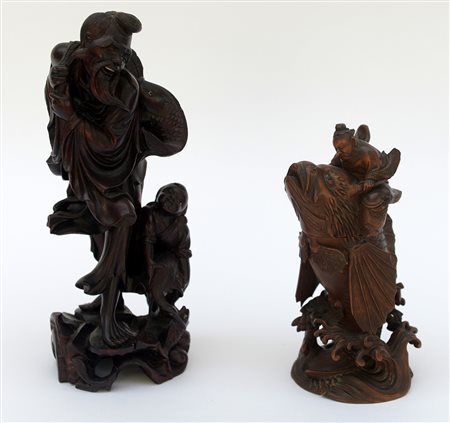 Due sculture in legno raffiguranti personaggi folkloristici orientali. Sec....