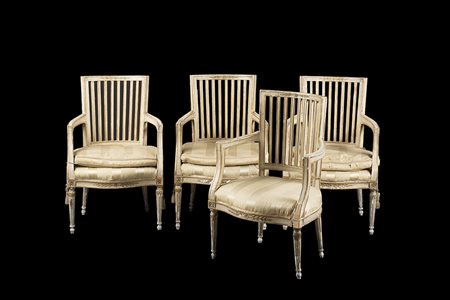 Gruppo di quattro poltrone in legno laccato e dorato con schienali a listelli...