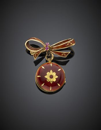 Spilla a fiocco in oro giallo con pendente portafoto, il tutto rifinito con...