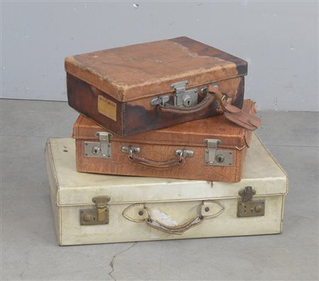 Lotto composto da tre vecchie valigie in cuoio, pergamena e finto coccodrillo...
