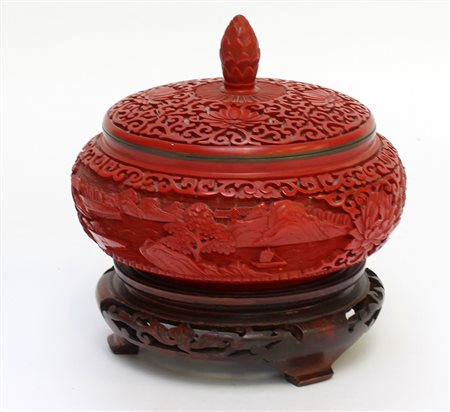 Scatola circolare con coperchio intagliata con paesaggio nei toni del rosso...