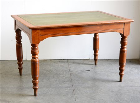 Scrittoio da centro con piano in marocchino verde impresso in oro, gambe...