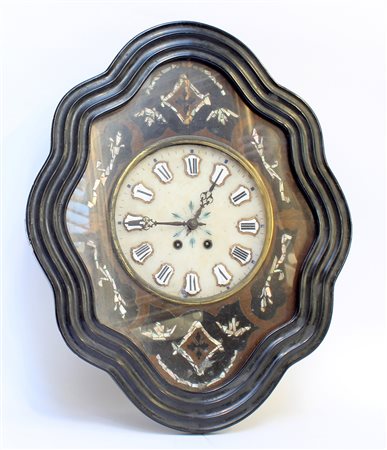 Orologio occhio di bue in legno ebanizzato con inserti in madreperla....