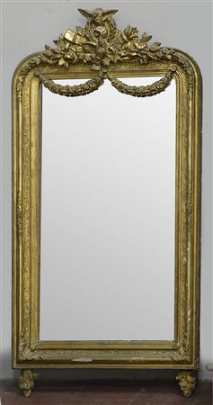 Specchiera con cornice in legno intagliato e dorato a decoro naturalistico....