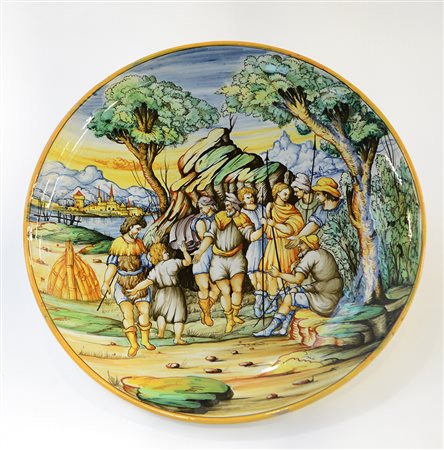 Manifattura del secolo XX. Piatto in maiolica istoriato decorato in...