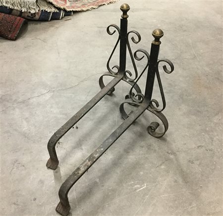 Coppia di alari in ferro battuto decorati da pinnacoli in bronzo tornito