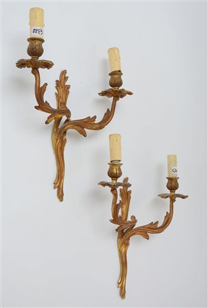 Coppia di applique a due luci in bronzo dorato (difetti)