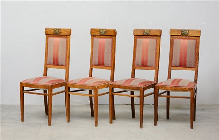 Gruppo di quattro sedie "Liberty" con schienale decorato da placca in metallo...