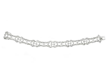 BRACCIALE IN PLATINO E DIAMANTI ad una linea di elementi sagomati e traforati...
