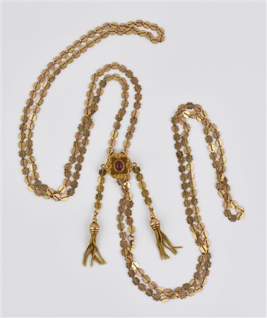 COLLANA SALISCENDI IN ORO A BASSO TITOLO E RUBINO realizzata ad una lunga...