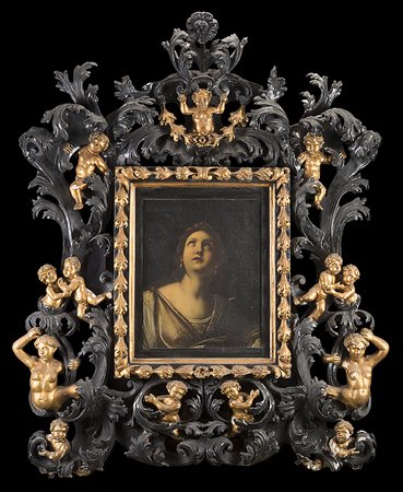 Ricca cornice barocca in legno intagliato, laccato e dorato a volute...