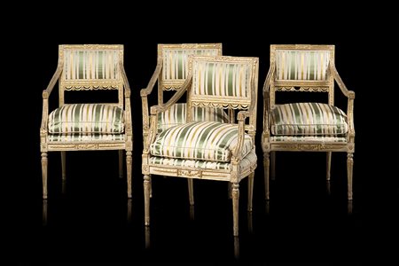 Gruppo di quattro poltrone in legno intagliato, laccato e dorato. Schienale...