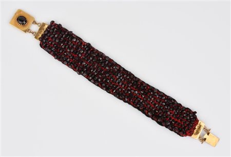 BRACCIALE IN STOFFA, GRANATI ED ORO A BASSO TITOLO modellato come un nastro a...