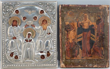 Lotto composto da due icone ad olio su tavola, una con riza in metallo...