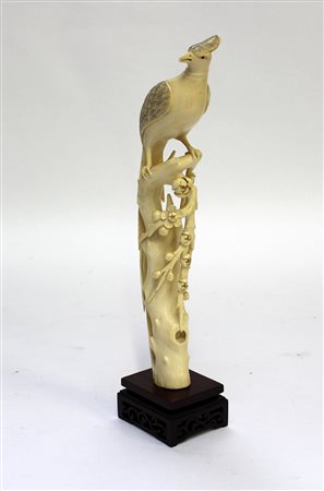 Fenice su ramo in avorio, base in legno (h. cm 30)Giappone, inizio sec. XX...